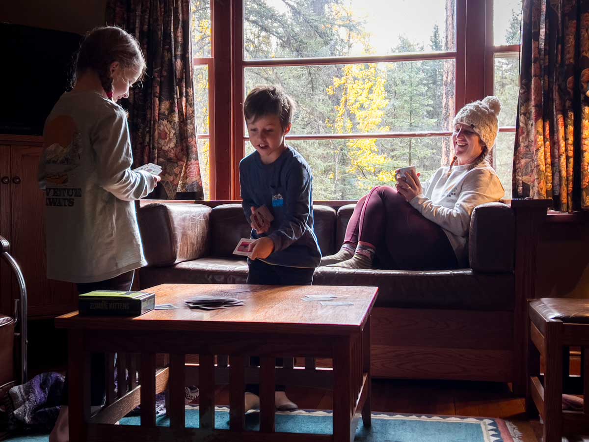 Kids playing cards while Staying at Johnston Canyon Cabins.