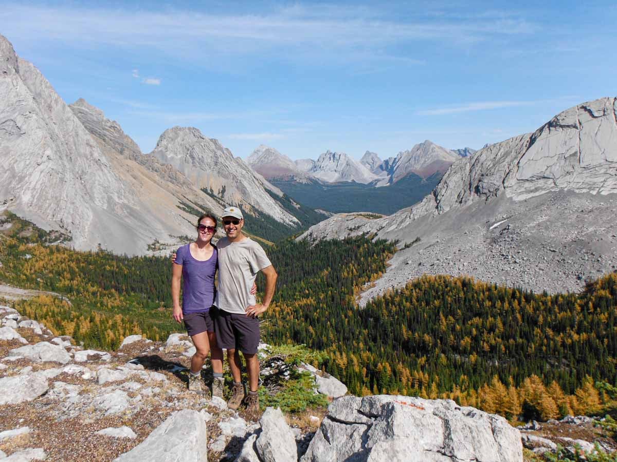 Dan and Celine Brewer, owners of TravelBanffCanada.com, stand atop Burstall Pass in the peak of the fall larch tree season.